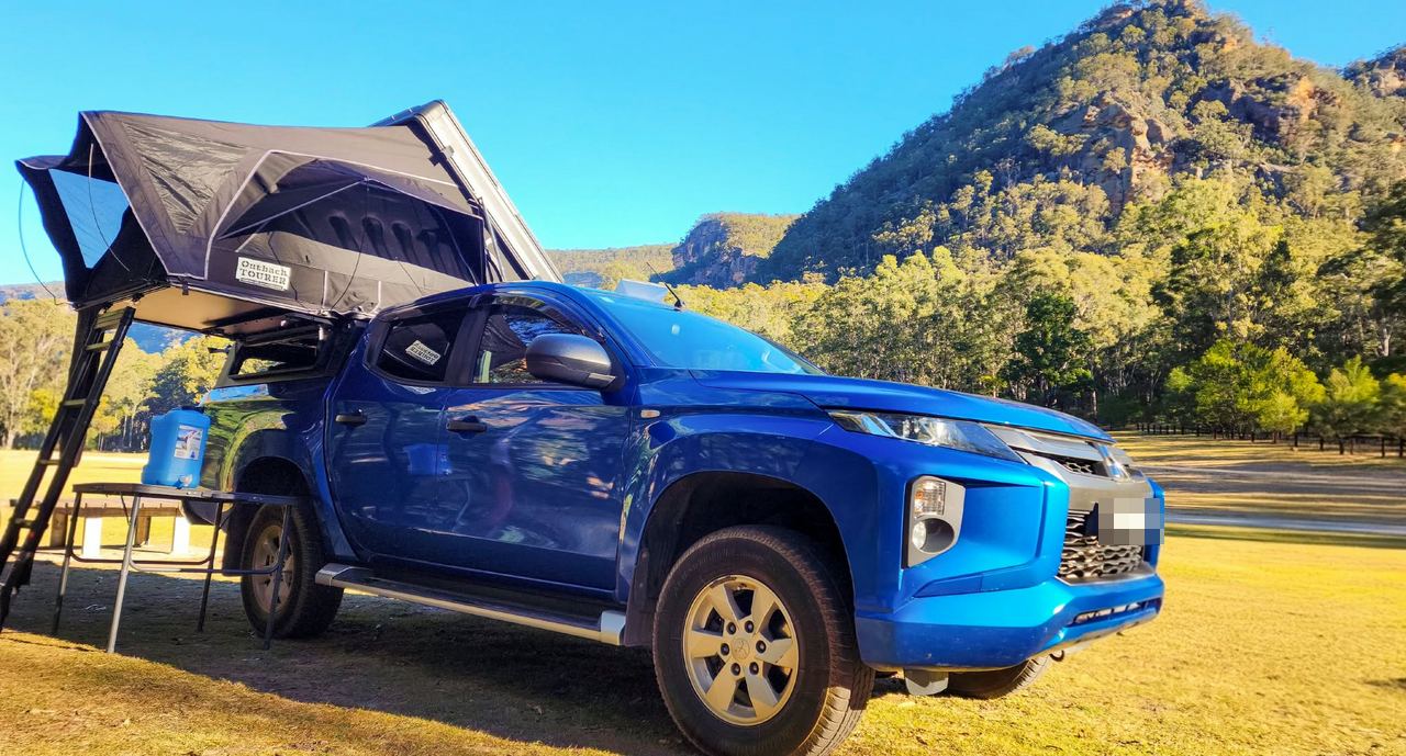 the Triton at camp with the rooftop tent up