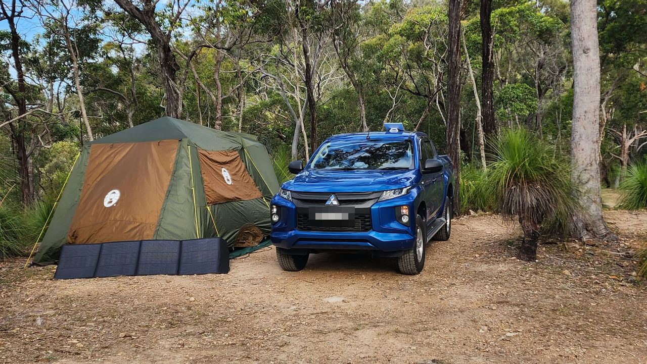 tent, ute and solar panels in the bush