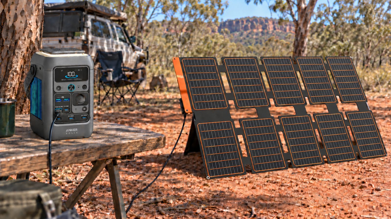 FlexSolar S100 unfolded in full sun at an Australian bush camp, charging an Anker SOLIX C300 DC power station on a camp table